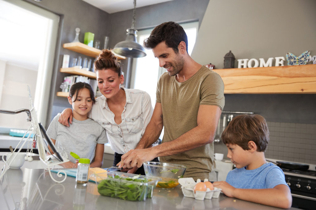 Family,In,Kitchen,Following,Recipe,On,Digital,Tablet,Together