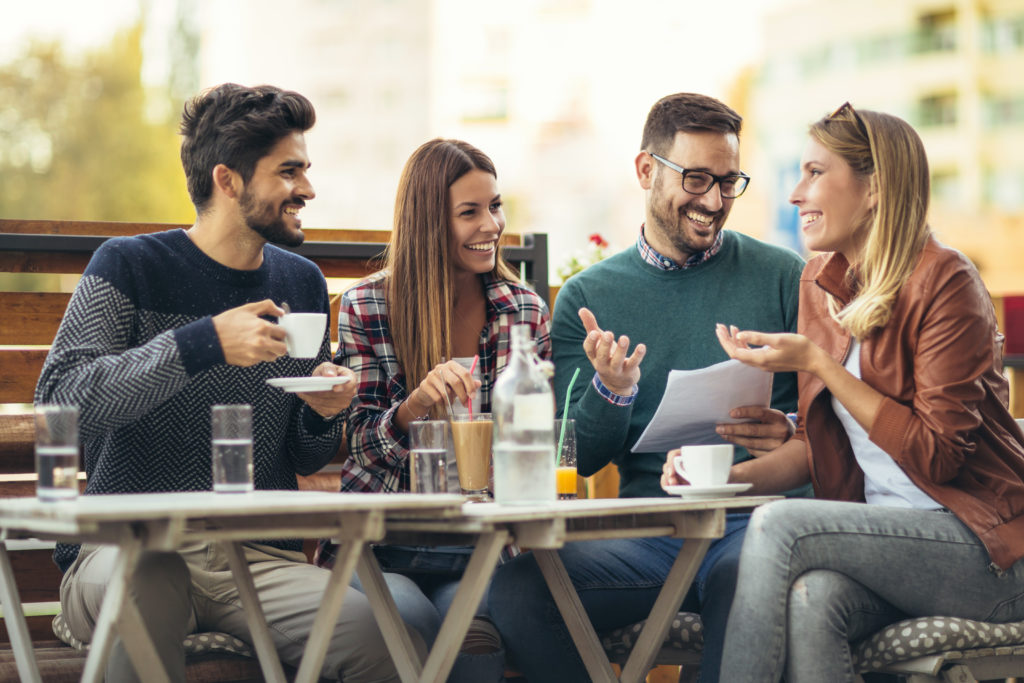 Group,Of,Four,Friends,Having,Fun,A,Coffee,Together.,Two