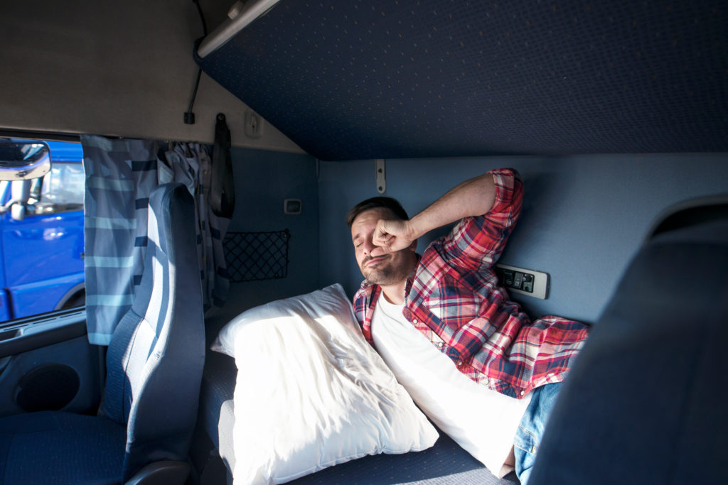 Truck,Cabin,Interior,With,Driver,Sleeping,In,Bed.,Truck,Driver